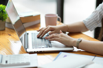 Success businesswoman typing on laptop keyboard, working on laptop
