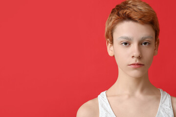 Teenage boy with dyed eyebrows on color background