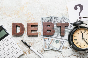 Word DEBT with calculator, money and alarm clock on grunge background