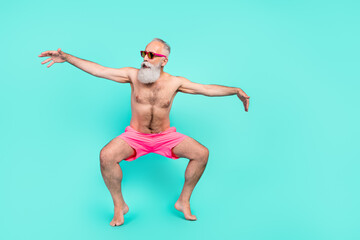 Photo of cool hipster senior man dance stand tiptoes wear sunglass shorts isolated turquoise color background
