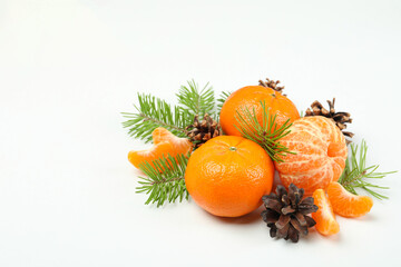Mandarins, cones and spruce branches on white background