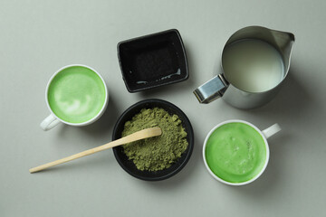 Matcha latte and accessories for making on light gray background