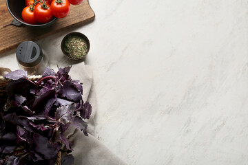 Basket with fresh basil on light background