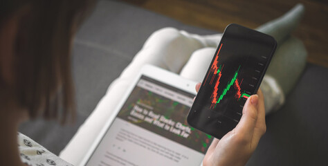 Stock market trading from home. Businesswoman with mobile phone cheking stock market chart price,...