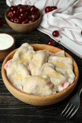 Concept of tasty food with pierogi with cherry on rustic wooden table