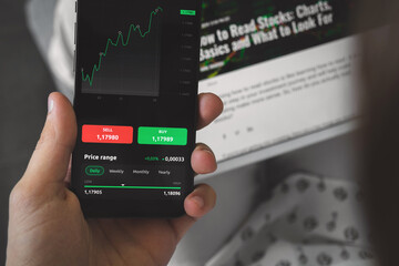 Trading stock market with smartphone at home. Trading online concept. Woman broker investment background