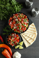 Mexican food concept with Pico de Gallo on dark wooden table