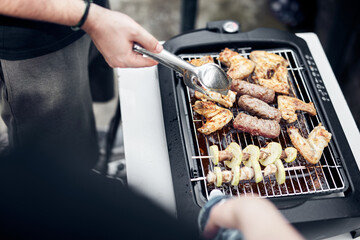 Preparing barbeque on a electrical modern grill outdoors.
