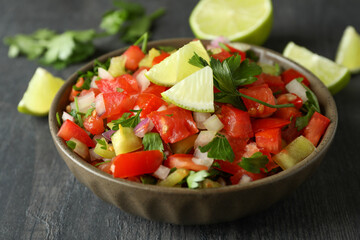Mexican food concept with Pico de Gallo on dark wooden table