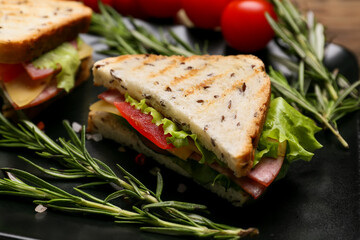 Plate with tasty sandwiches on table, closeup
