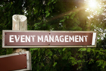 Event management concept. Road sign and arrow. Wooden construction