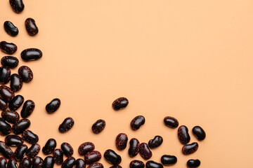 Raw beans on color background