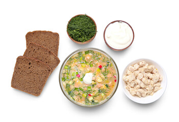 Bowl with tasty okroshka, bread and ingredients on white background