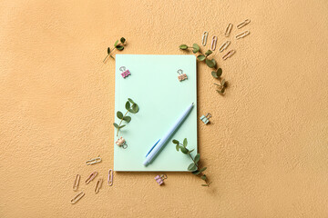 Composition with stationery supplies and plant branches on color background