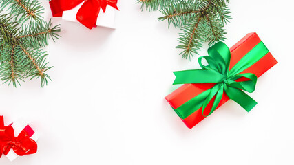 Flat lay composition with gift boxes and Christmas decorations on white table, space for text
