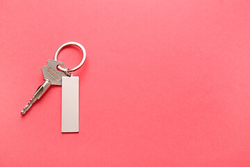 Key with stylish keychain on color background