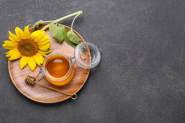 Jar of honey on dark background