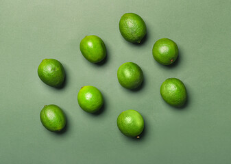 Tasty limes on color background