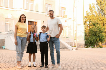 Fototapeta premium Cute little children going to school with their parents