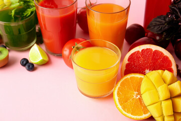 Glasses with healthy juice, fruits and vegetables on color background