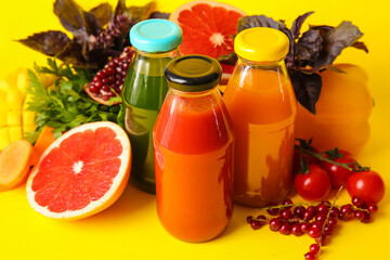 Bottles with healthy juice, fruits and vegetables on color background