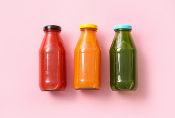 Bottles with healthy juice on color background