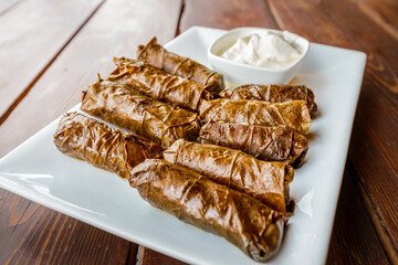 dolma is a large family of traditional dishes of grape leaf snacks stuffed with various fillings. It is widespread in Transcaucasia and Turkey
