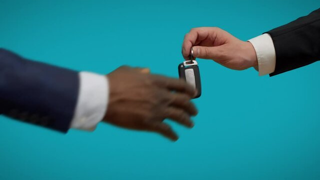 Car dealer giving keys to customer, test drive, automobile purchase, agreement
