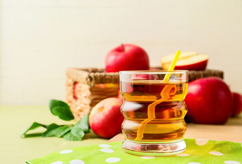 Glass of tasty apple juice on table, closeup