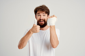 male patient in a white T-shirt with a bandaged hand posing hospital medicine