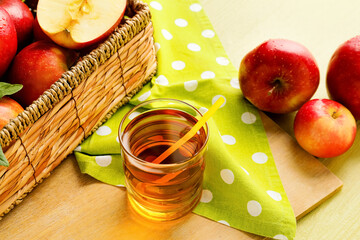 Glass of tasty apple juice on wooden background