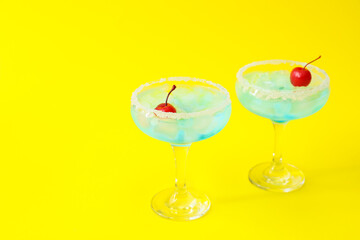 Glasses of Blue Lagoon cocktail on color background