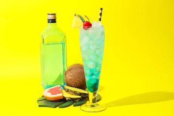 Glass of Blue Lagoon cocktail on color background