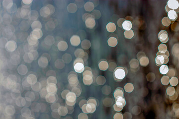 Blurred fence background around pond and sun glare on water