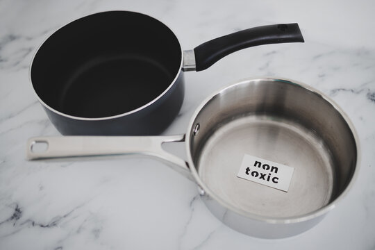 healthy cooking concept, stainless steel vs non stick saucepan side by side with Non Toxic label on the first one