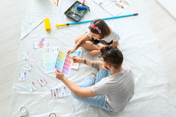 Young couple with palette samples planning design of their new house