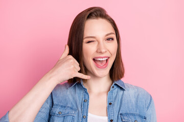 Photo portrait of girl smiling asking to call her winking blinking isolated pastel pink color...