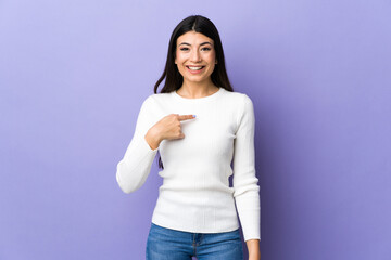 Young brunette woman over isolated purple background with surprise facial expression