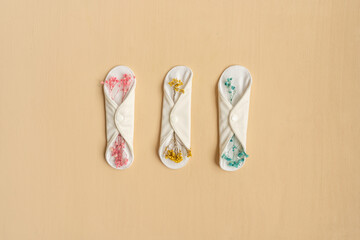 Reusable eco natural pad with flowers on beige.