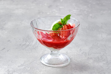 Ice cream with strawberry jam in a bowl