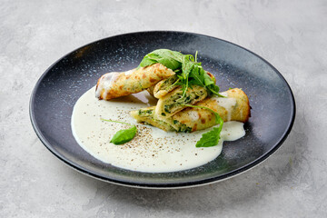 Thin crepe stuffed with cheese, arugula and spinach