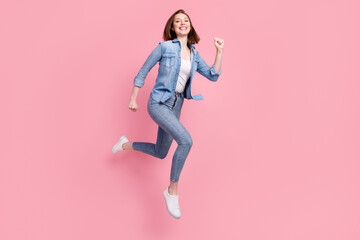 Fototapeta na wymiar Full length body size photo girl jumping running fast smiling isolated pastel pink color background