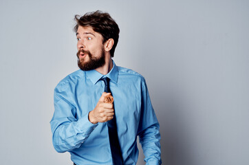 a man in a shirt with a tie cryptocurrency bitcoin in the hands of an internet investment manager