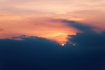 Sun rising. Beautiful nature scene with sunrise through thick dark clouds in early the morning. Great motivation view for your energy and positive attitude of mind.