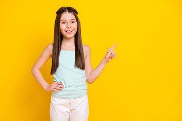 Portrait of attractive cheerful girl showing copy empty space index select decision isolated over bright yellow color background