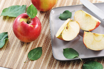 ripe red apples and cut into slices with a leaf