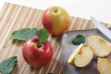 ripe red apples and cut into slices with a leaf