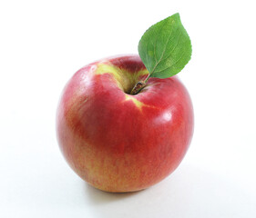 ripe red apple with green leaf