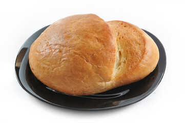round bread isolated on black plate