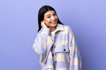 Young brunette woman over isolated purple background thinking an idea